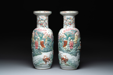 A pair of Chinese famille rose '18 luohan' vases with relief design, 19th C.