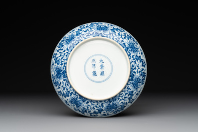 A Chinese blue and white 'flower scroll' plate, Yongzheng mark and of the period