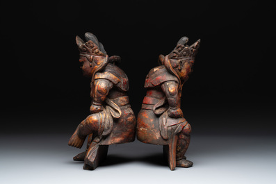 A pair of Chinese gilt-lacquered wooden sculptures of guardians, Qing