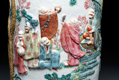 A pair of Chinese famille rose '18 luohan' vases with relief design, 19th C.