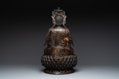 An impressive and large Chinese partially lacquered and gilt bronze Guanyin on a lotus throne, Ming