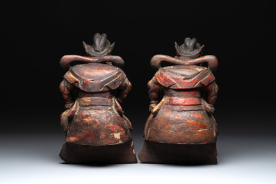 A pair of Chinese gilt-lacquered wooden sculptures of guardians, Qing