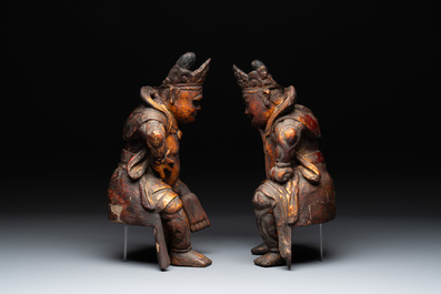 A pair of Chinese gilt-lacquered wooden sculptures of guardians, Qing