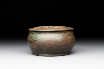 A rare Chinese bronze 'sage in a mountainous landscape' handwarmer, 17/18th C.