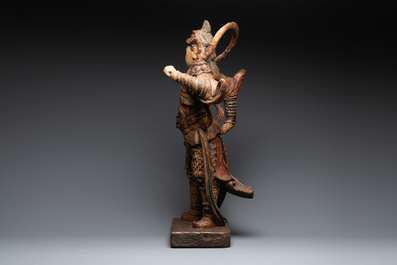 A large Chinese polychrome-lacquered wooden figure of a Guardian King, 18/19th C.