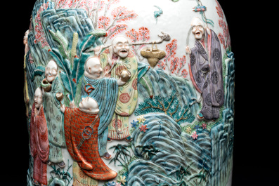 A pair of Chinese famille rose '18 luohan' vases with relief design, 19th C.