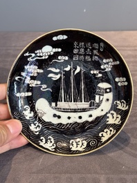 A Chinese iron-red 'bat' saucer and a black-glazed 'ship' saucer with calligraphy, Guangxu mark, 19th C.