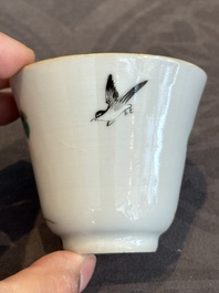 A pair of Chinese famille rose 'monkey and deer' cups and saucers, Tongzhi mark and of the period