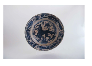 A rare Spanish blue and white pottery 'lion' dish from the 'mariposas' series, Puente del Arzobispo, Toledo, 16th C.