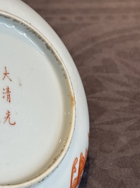 A Chinese iron-red 'bat' saucer and a black-glazed 'ship' saucer with calligraphy, Guangxu mark, 19th C.