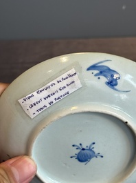 A Chinese iron-red 'bat' saucer and a black-glazed 'ship' saucer with calligraphy, Guangxu mark, 19th C.