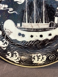 A Chinese iron-red 'bat' saucer and a black-glazed 'ship' saucer with calligraphy, Guangxu mark, 19th C.