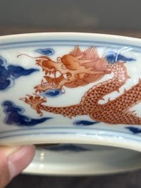 An imperial Chinese blue, white and iron-red 'dragon' plate, Qianlong mark and of the period