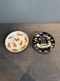 A Chinese iron-red 'bat' saucer and a black-glazed 'ship' saucer with calligraphy, Guangxu mark, 19th C.