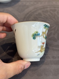 A pair of Chinese famille rose 'monkey and deer' cups and saucers, Tongzhi mark and of the period