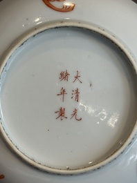 A Chinese iron-red 'bat' saucer and a black-glazed 'ship' saucer with calligraphy, Guangxu mark, 19th C.