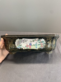 A Chinese Canton enamel gilt-decorated dark-green-ground jardini&egrave;re with four inserted plaques, Qianlong/Jiaqing