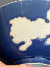 A Chinese powder blue-ground biscuit, blue and white 'Buddhist lion' bowl, Xuande mark, Kangxi