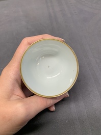 A Chinese export famille rose cup and saucer with a herring merchant, Qianlong