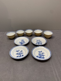 Five Chinese caf&eacute;-au-lait-ground blue and white cups and four saucers, conical shell mark, Kangxi