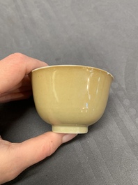 Five Chinese caf&eacute;-au-lait-ground blue and white cups and four saucers, conical shell mark, Kangxi