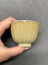Five Chinese caf&eacute;-au-lait-ground blue and white cups and four saucers, conical shell mark, Kangxi