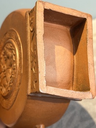 A Chinese circle-shaped Yixing stoneware 'kylin' teapot with relief design, Kangxi