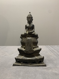 A Laotian bronze figure of a seated Buddha, 19th C.