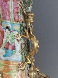 A pair of Chinese Canton famille rose vases with narrative design, 19th C.