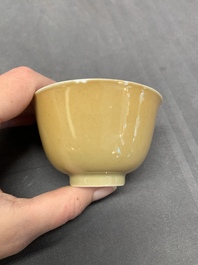 Five Chinese caf&eacute;-au-lait-ground blue and white cups and four saucers, conical shell mark, Kangxi