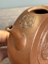 A Chinese circle-shaped Yixing stoneware 'kylin' teapot with relief design, Kangxi