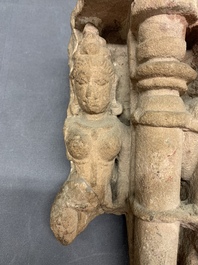 An Indian architectural red sandstone fragment with divinities, 13th C.