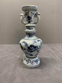 A pair of Chinese blue and white handled vases with floral design, Ming
