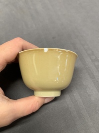 Five Chinese caf&eacute;-au-lait-ground blue and white cups and four saucers, conical shell mark, Kangxi