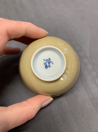 Five Chinese caf&eacute;-au-lait-ground blue and white cups and four saucers, conical shell mark, Kangxi