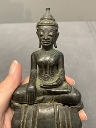 A Laotian bronze figure of a seated Buddha, 19th C.
