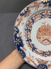 Two Chinese famille rose plates and an Imari-style armorial plate, Kangxi/Yongzheng