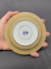 Five Chinese caf&eacute;-au-lait-ground blue and white cups and four saucers, conical shell mark, Kangxi