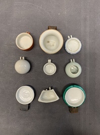 A collection of nine Chinese blue and white, monochrome and famille rose bird feeders, 19th C.