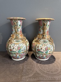A pair of Chinese Canton famille rose vases with narrative design, 19th C.