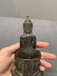 A Laotian bronze figure of a seated Buddha, 19th C.