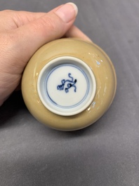 Five Chinese caf&eacute;-au-lait-ground blue and white cups and four saucers, conical shell mark, Kangxi
