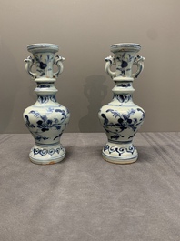 A pair of Chinese blue and white handled vases with floral design, Ming