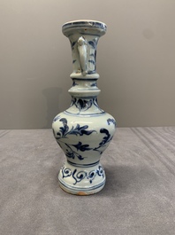 A pair of Chinese blue and white handled vases with floral design, Ming