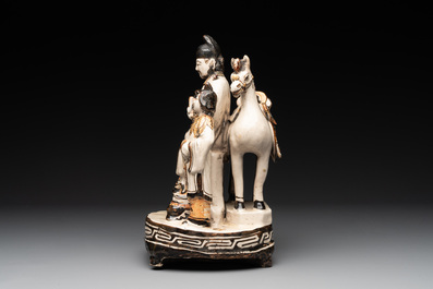 A rare Chinese Cizhou group with a dignitary, two attendants and a horse, Ming