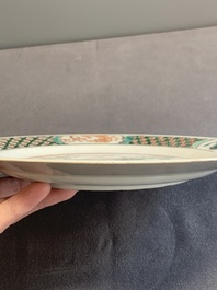 A pair of Chinese famille verte plates with figures along the riverside, artemisia leaf and ding mark, Kangxi