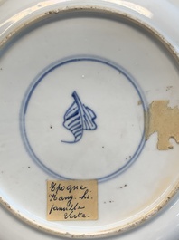 A pair of Chinese famille verte plates with figures along the riverside, artemisia leaf and ding mark, Kangxi