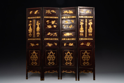 A Chinese four-part reticulated and partially gilt wooden folding screen, 19th C.