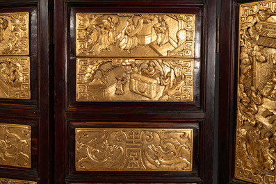 A Chinese four-part reticulated and partially gilt wooden folding screen, 19th C.
