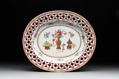 A Chinese openworked famille rose 'antiquities' basket and stand, Qianlong